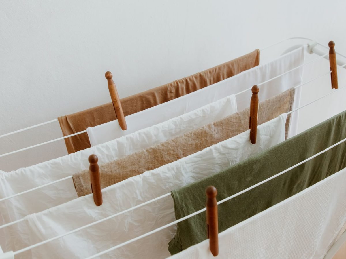 Fresh laundry drying over a wall-mounted rack.