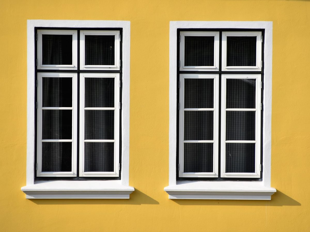 White uPVC-framed windows set into a bright wall.